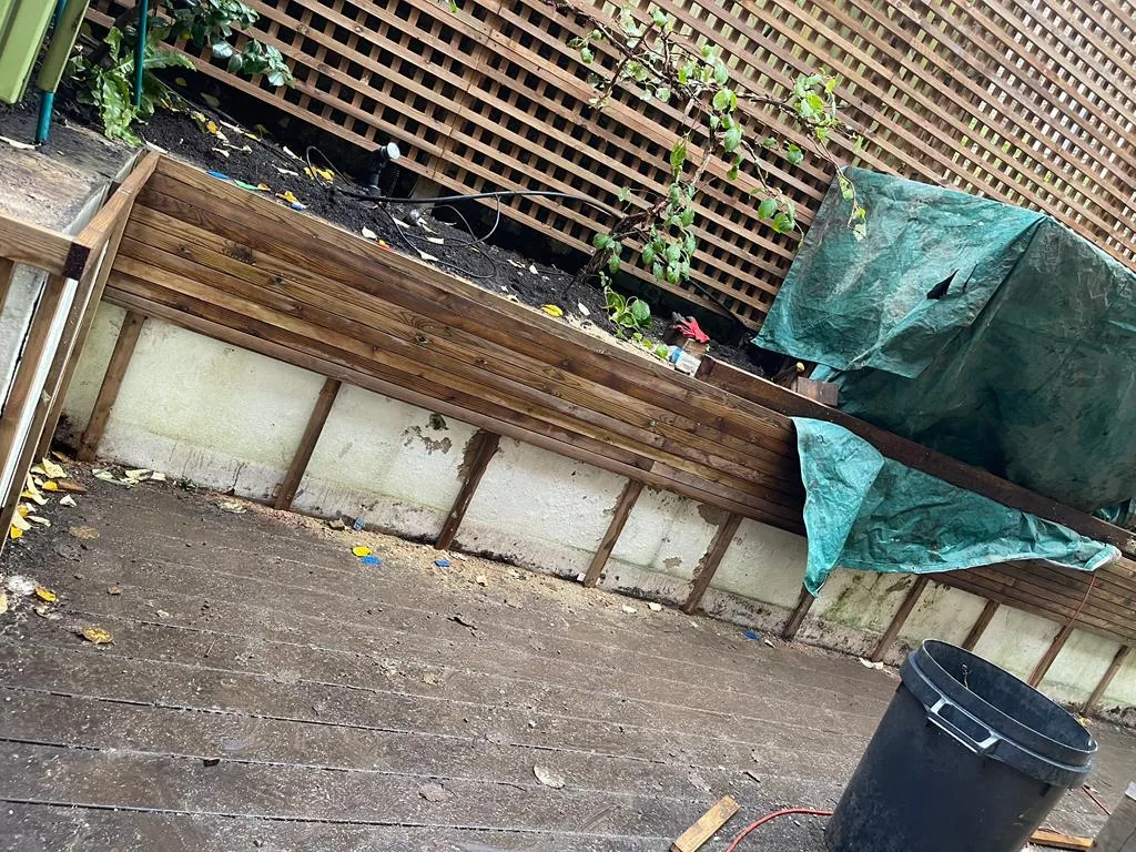 Slatted trellis panels above timber fence