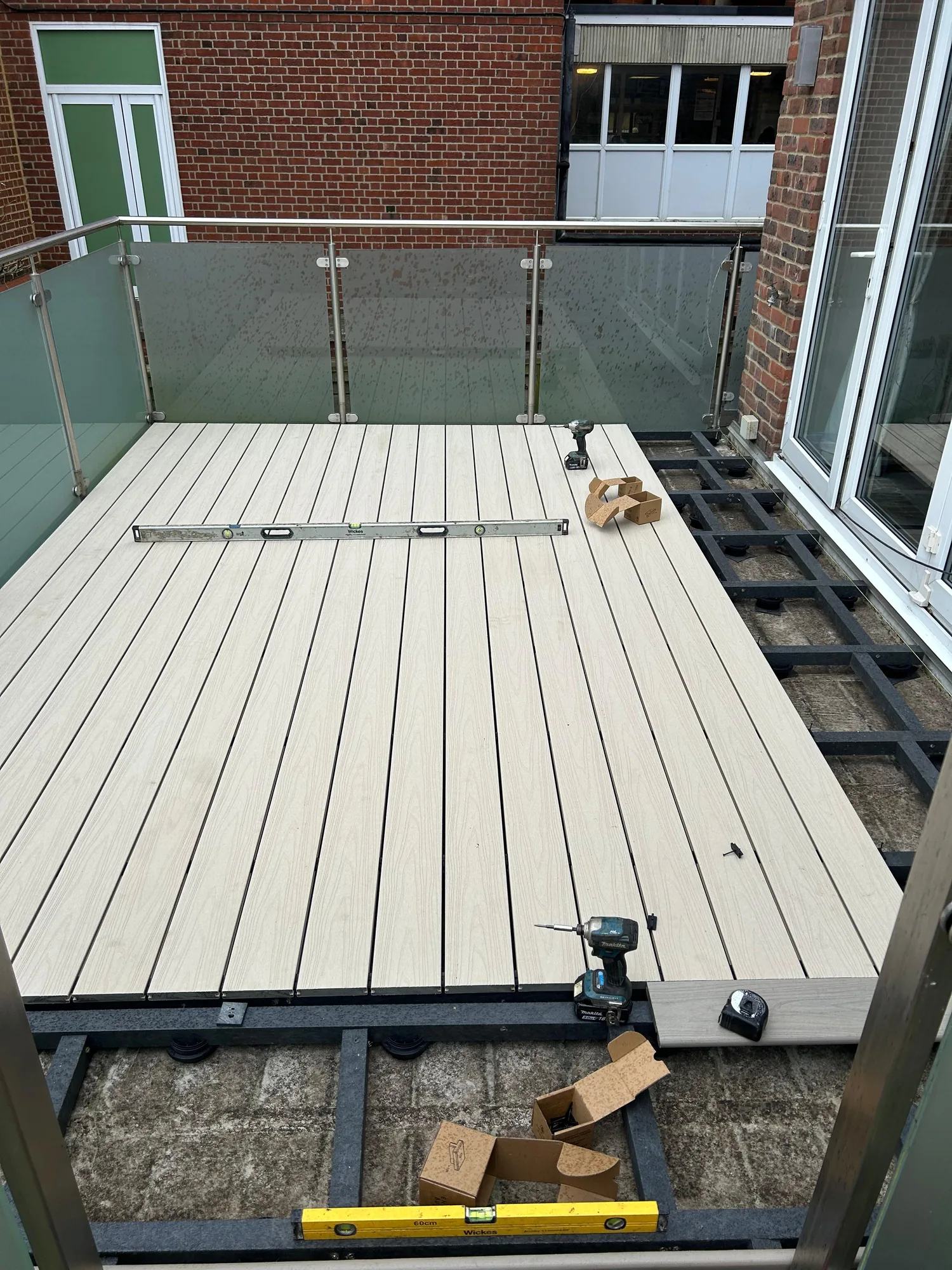 During: composite boards partway through install, with the remaining old section visible